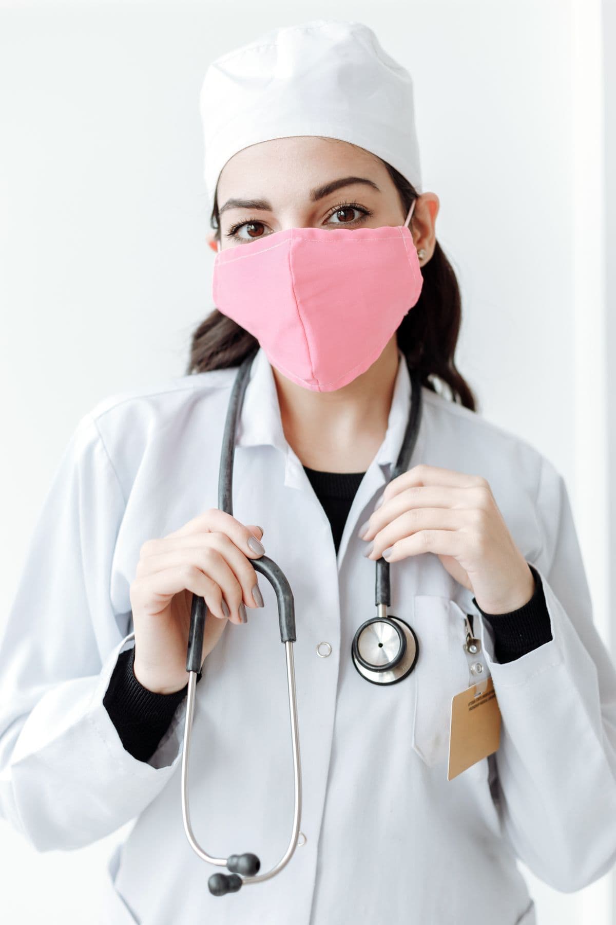 Nurse in a white coat with a stethoscope, ready to help